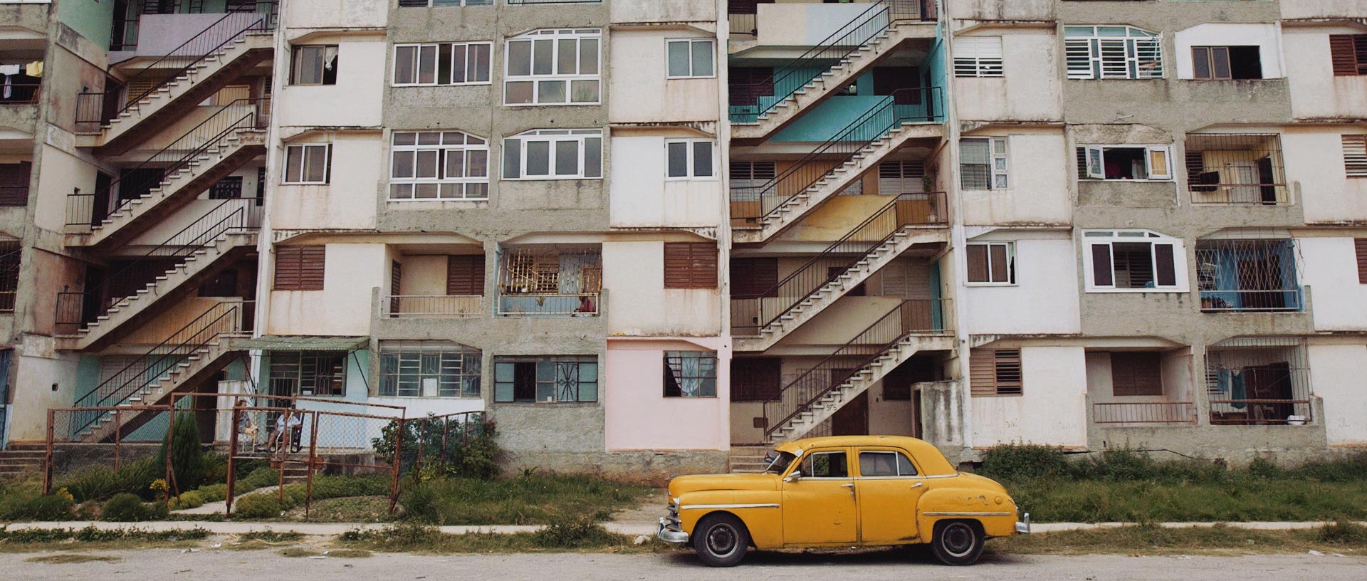 Apartments and yellow car