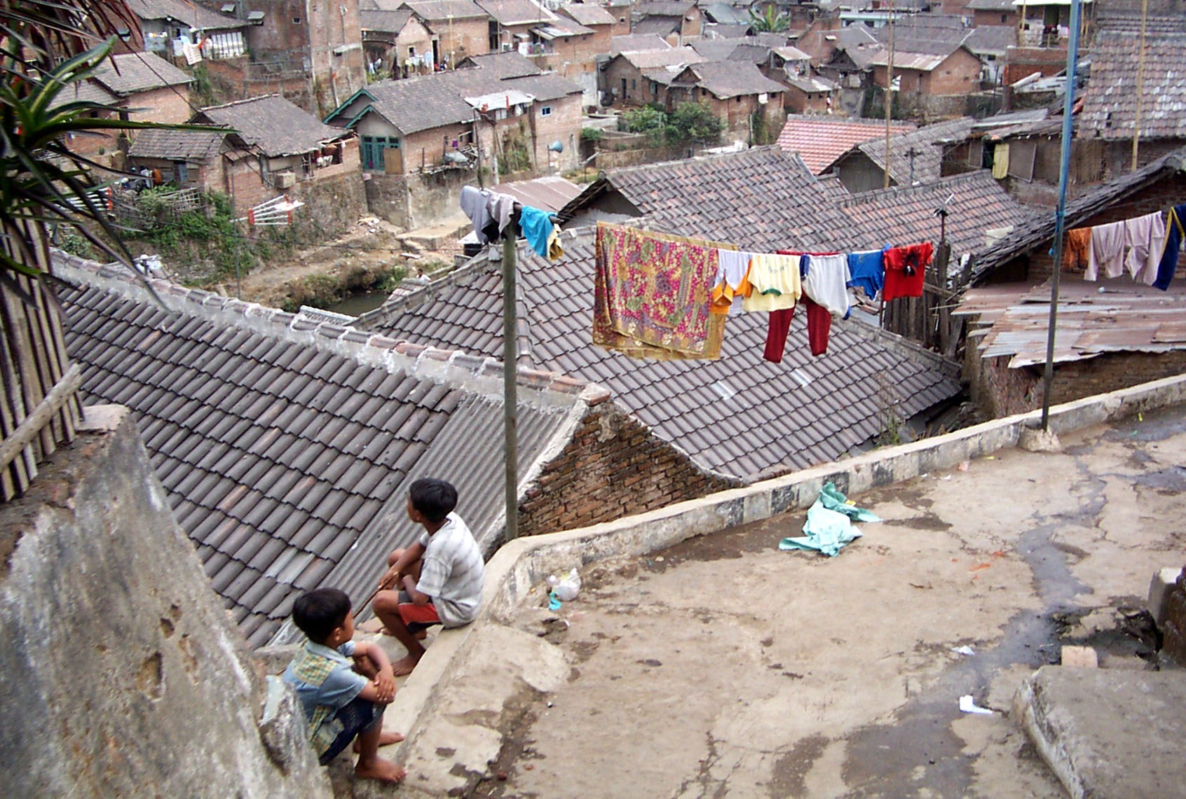Boys looking at informal housing settlement. 