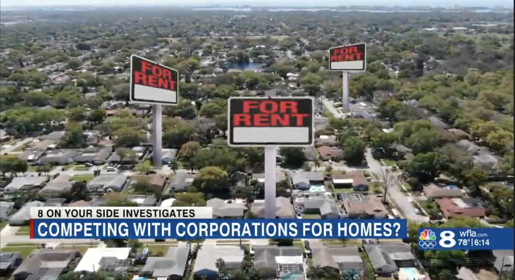 aerial view of a neighborhood with for sale signs