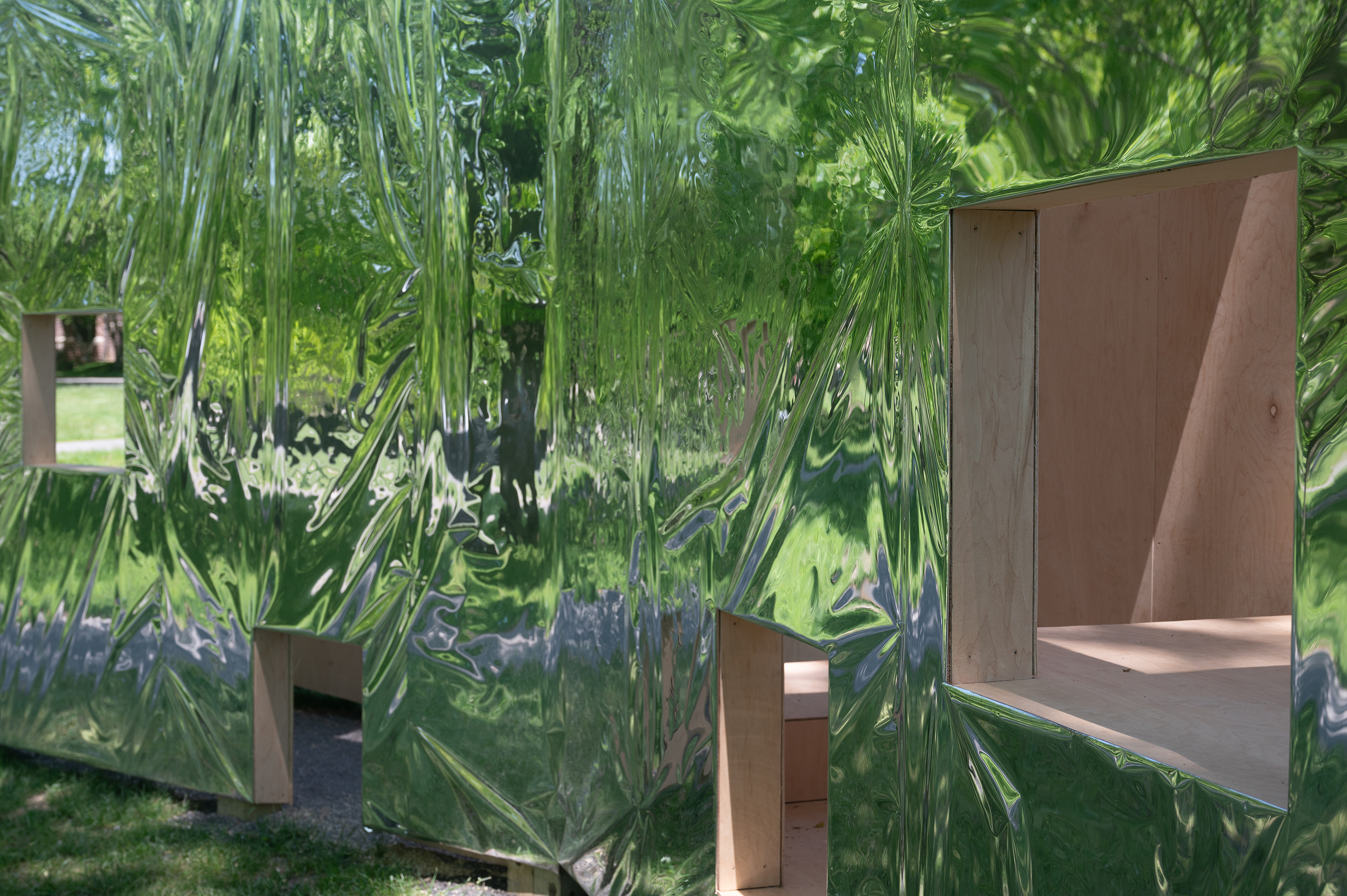 detailed view of facade of pavilion reflecting distorted surroundings