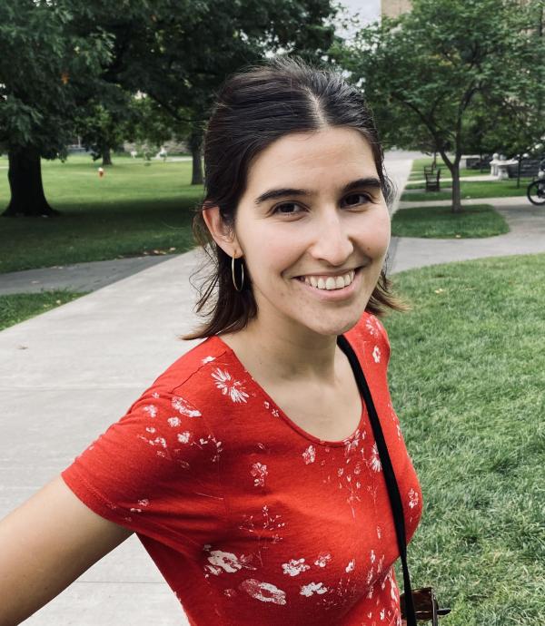 women in red shirt standing on a sidewalk