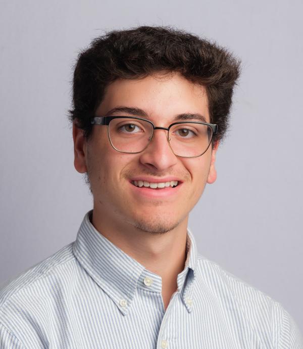 Headshot of young man with glasses