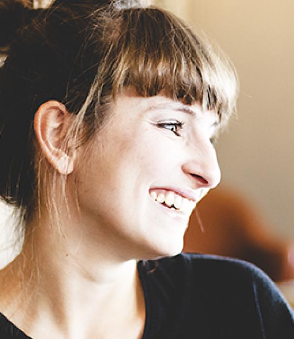 Headshot of woman with updo and bangs