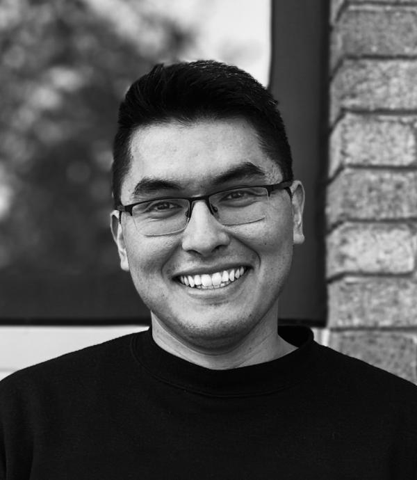 Black and white headshot photo of smiling young man.