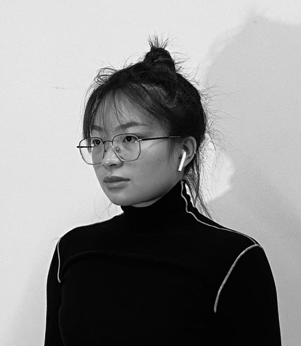 Black and white headshot of young woman with glasses