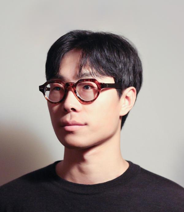 Headshot of young man with glasses