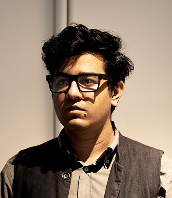 Headshot of a young man with glasses