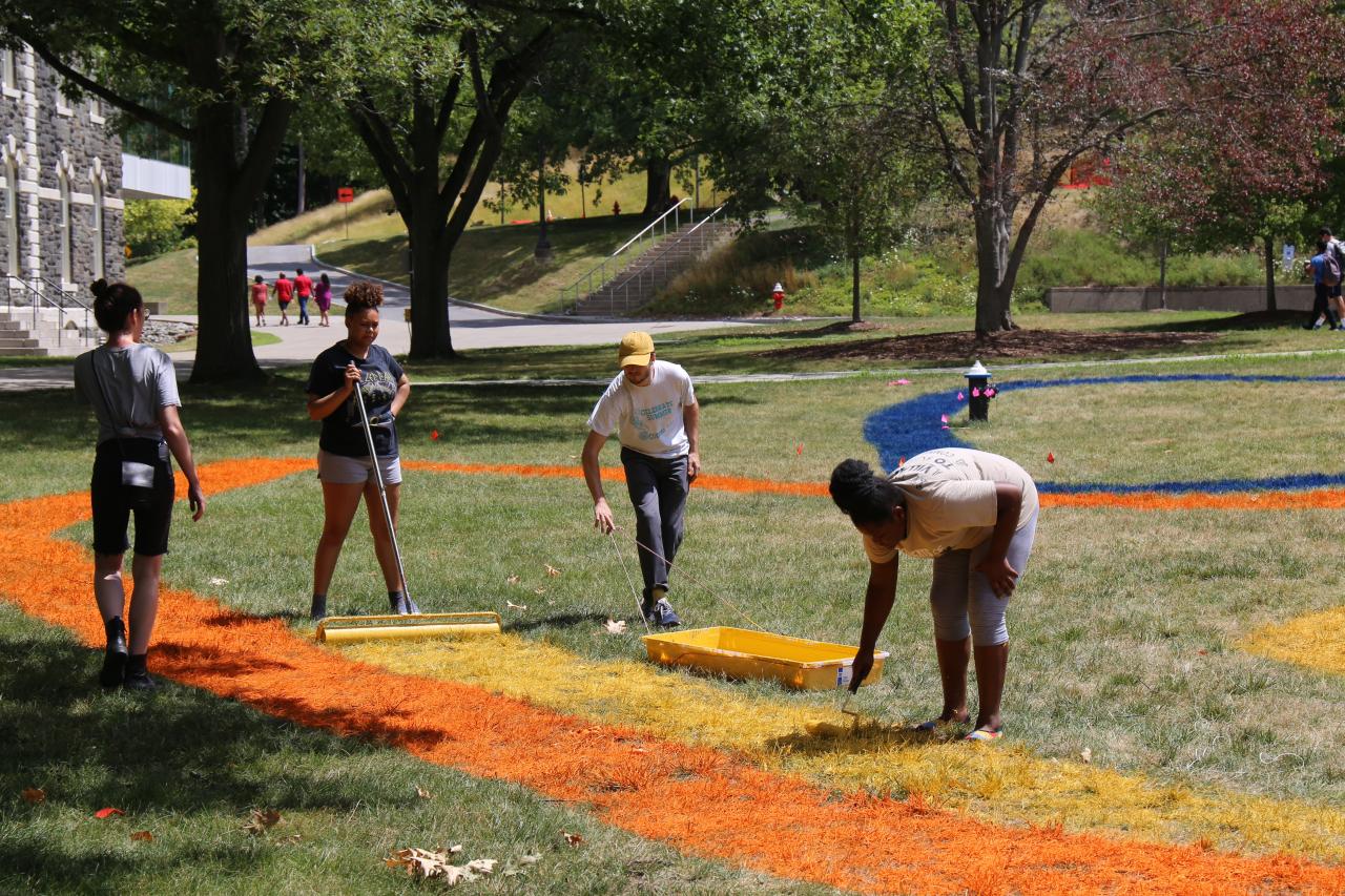 Local high school students painting with AAP mentors