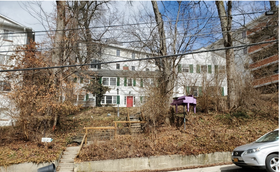 Photo taken by Kelsey Coats on March 8, 2022. The photo shows the street view of 228 Dryden. The purple piano is an attention grabber to anyone walking along the street.