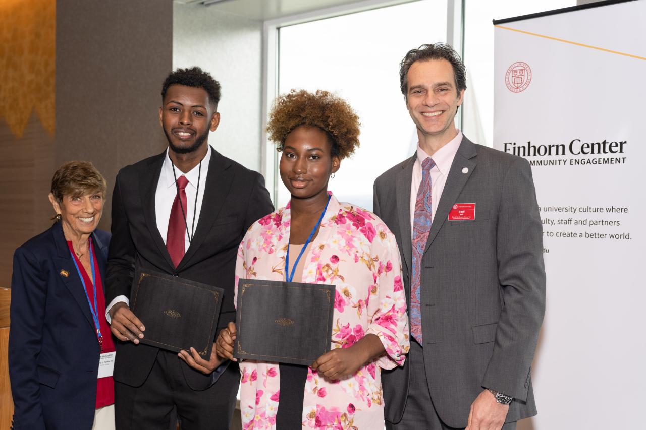 Photograph of Najeh Abduljalil and Alisha Robbins receiving a grant award from Cornell's Einhorn Office of Engagement Initiatives