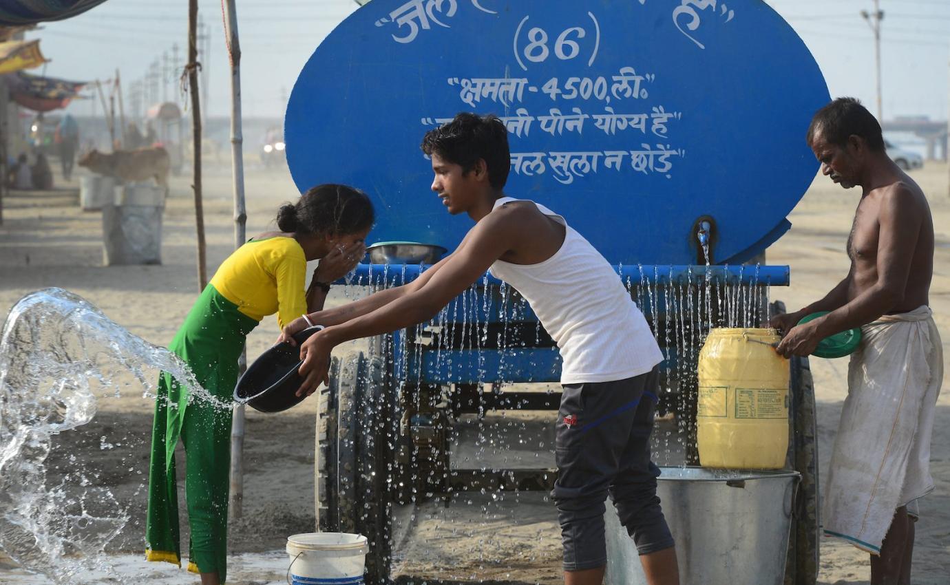 Indian people get water from a tanker with the Allahabad municipal corporation