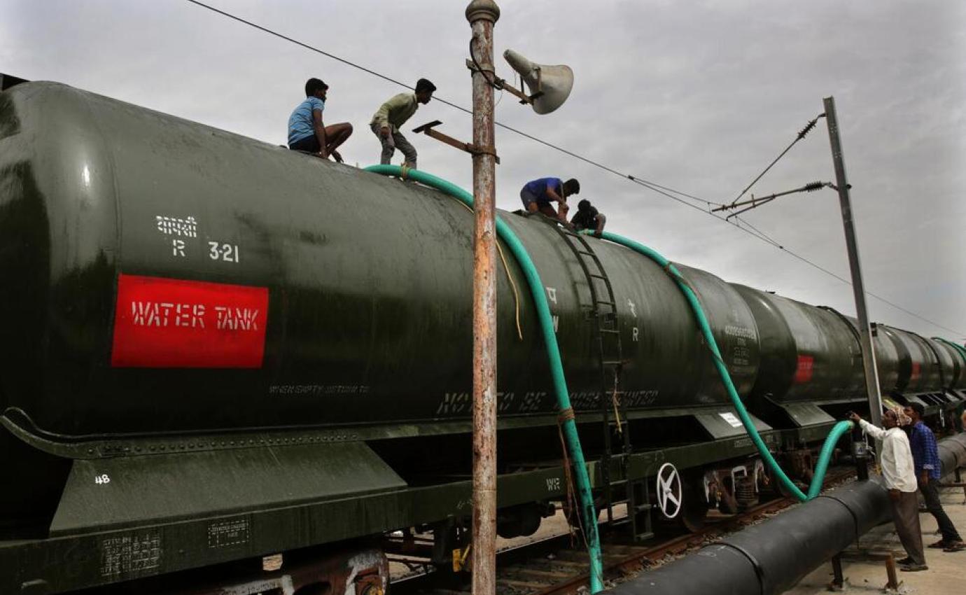 Water tanker train being filled by workers en route to Chennai, India