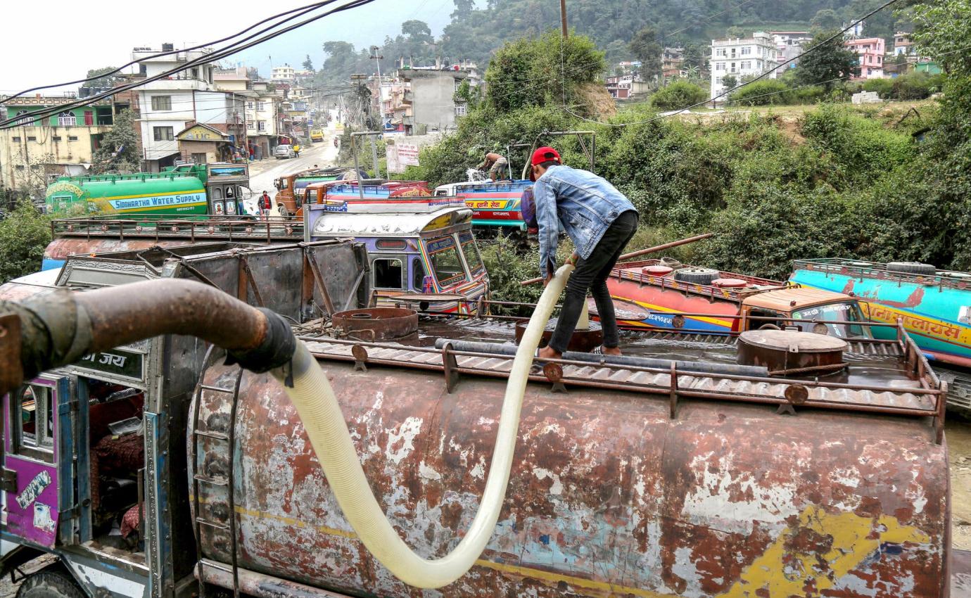 A worker pumping water from the Khahare River to supply a tanker in Kirtipur, Kathmandu.