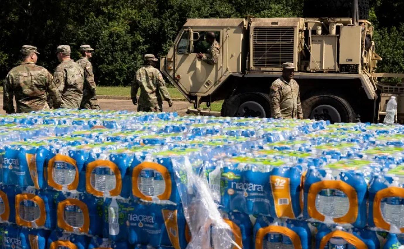 JACKSON, MS - SEPTEMBER 01: A truck carrying non-potable water, water that can be used for flushing toilets and cleaning but not drinking, arrives at Thomas Cardozo Middle School where personnel from the Mississippi National Guard were also handing out bottled water in response to the water crisis on September 01, 2022 in Jackson, Mississippi. Jackson has been experiencing days without reliable water service after river flooding caused the main treatment facility to fail. BRAD VEST VIA GETTY IMAGES