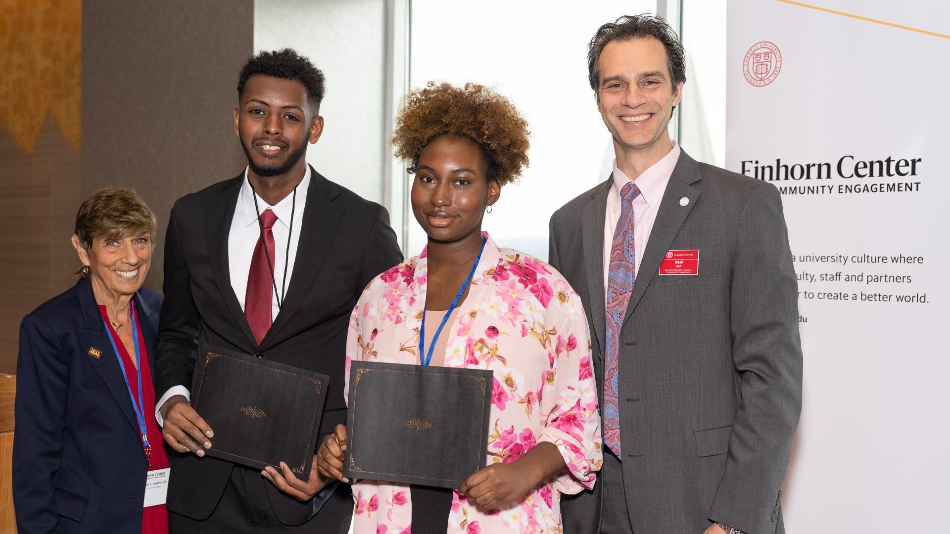 Photograph of Najeh Abduljalil and Alisha Robbins receiving a grant award from Cornell's Einhorn Office of Engagement Initiatives